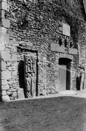 OLD SCULPTURED STONES IN OLD WALL